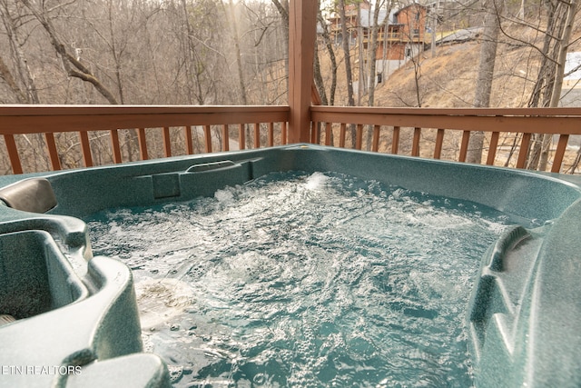 wooden terrace with a hot tub