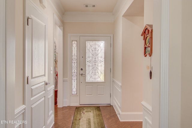 doorway to outside featuring ornamental molding and light wood-type flooring