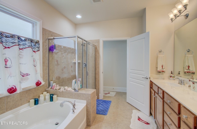 bathroom featuring vanity, tile patterned floors, and separate shower and tub