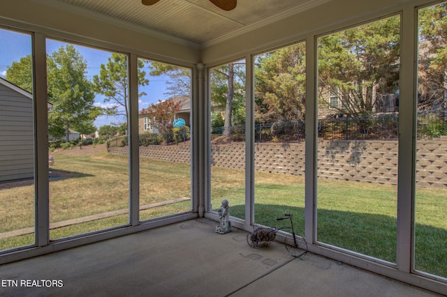 unfurnished sunroom with ceiling fan