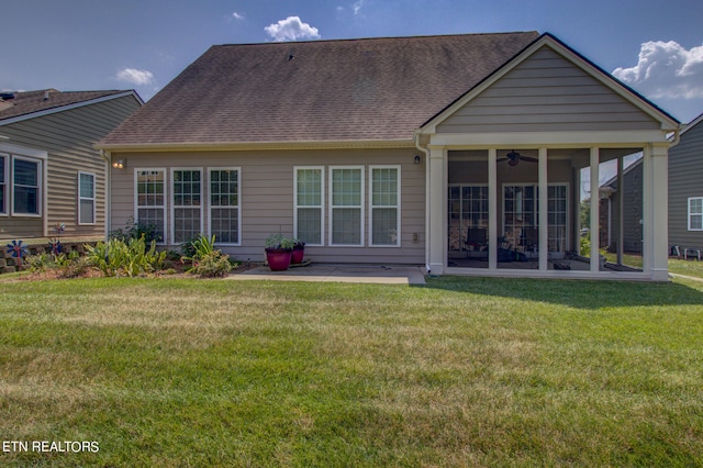 rear view of property with a patio, a yard, and ceiling fan