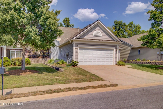 view of front of house with a garage and a front lawn