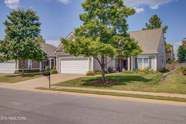 obstructed view of property with a garage and a front yard