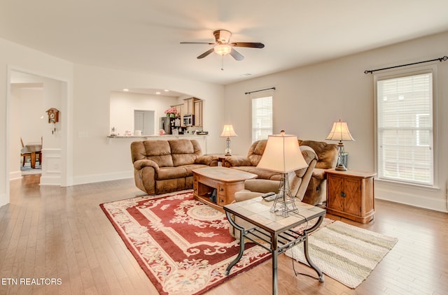 living room with hardwood / wood-style floors and ceiling fan