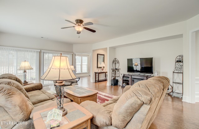 living room featuring hardwood / wood-style flooring and ceiling fan