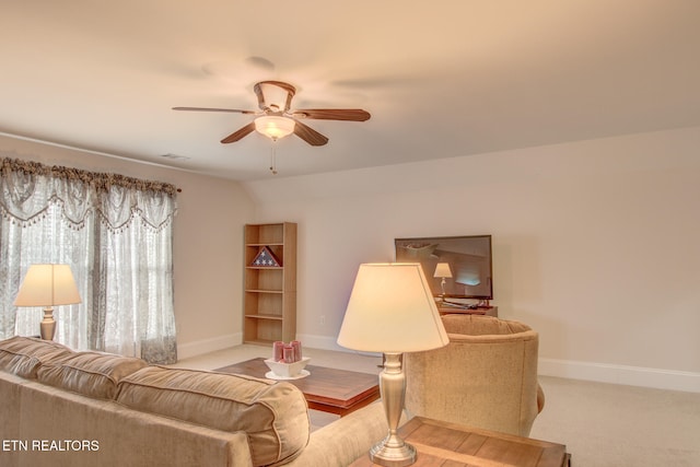 living room with light colored carpet, ceiling fan, and vaulted ceiling