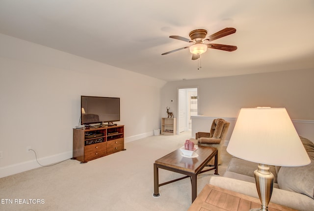 carpeted living room with ceiling fan