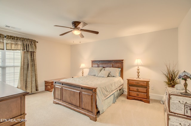 bedroom featuring ceiling fan and light carpet