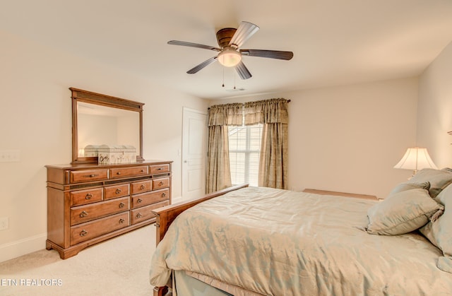 bedroom with light colored carpet and ceiling fan