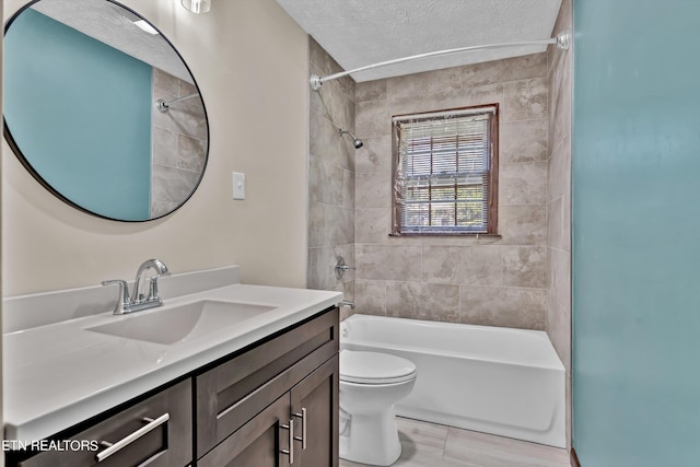 full bathroom with a textured ceiling, tub / shower combination, vanity, and toilet