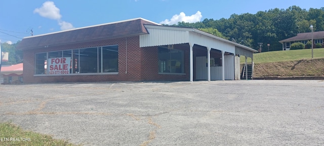 view of property exterior with a carport