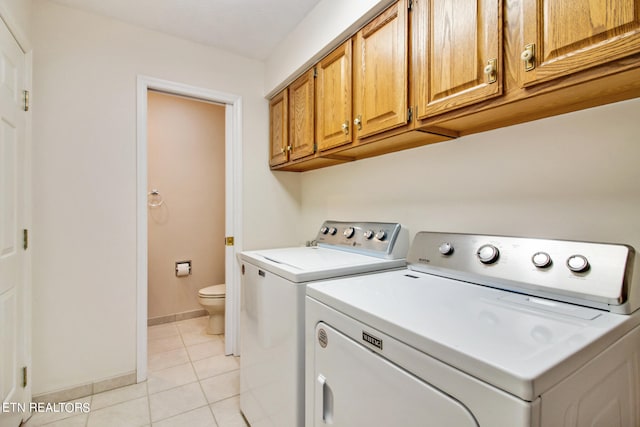 laundry room with light tile patterned flooring and washing machine and dryer