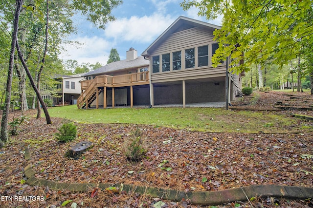 rear view of house featuring a wooden deck