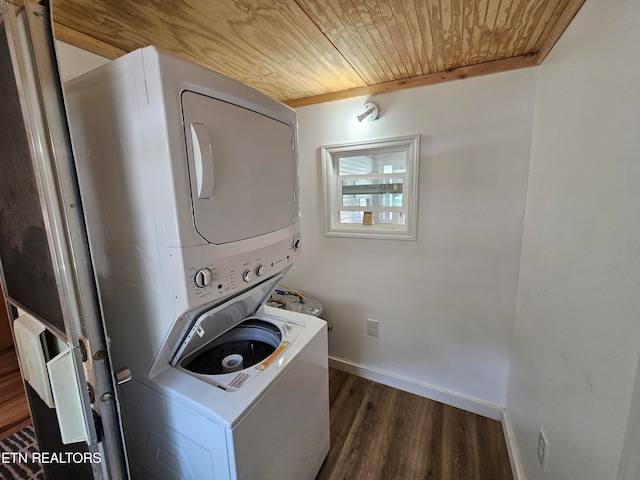 clothes washing area featuring wood ceiling, dark hardwood / wood-style flooring, and stacked washer and dryer