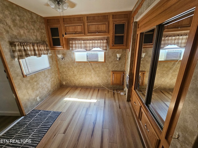 kitchen featuring cooling unit, ceiling fan, and wood-type flooring