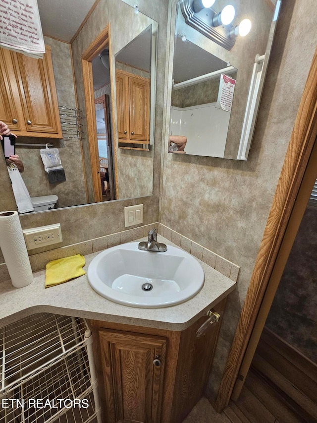 bathroom featuring vanity and tile walls