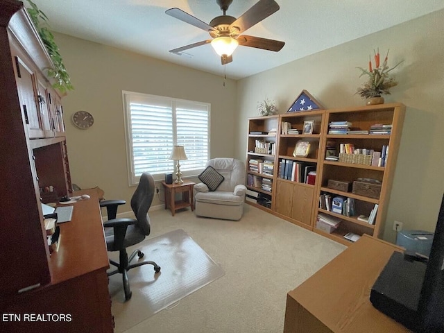 carpeted office featuring a ceiling fan