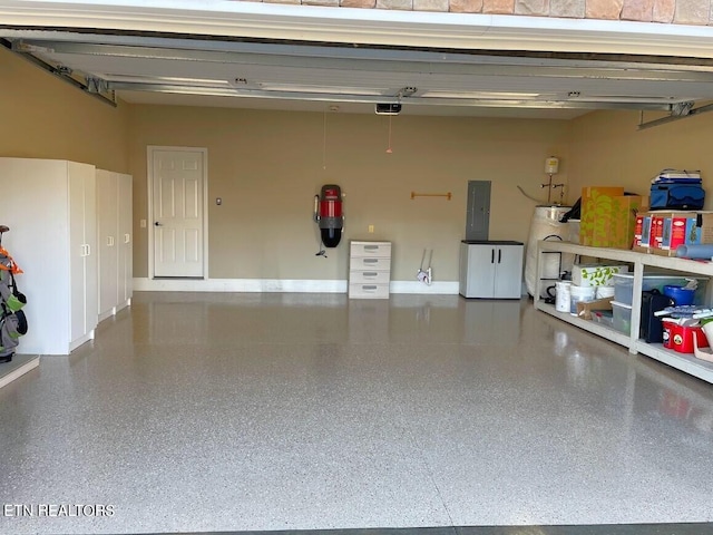 garage with water heater, electric panel, baseboards, and a garage door opener