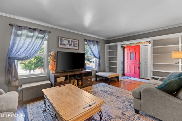 living room with crown molding, a healthy amount of sunlight, and hardwood / wood-style flooring