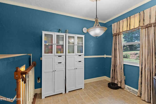 unfurnished dining area featuring ornamental molding