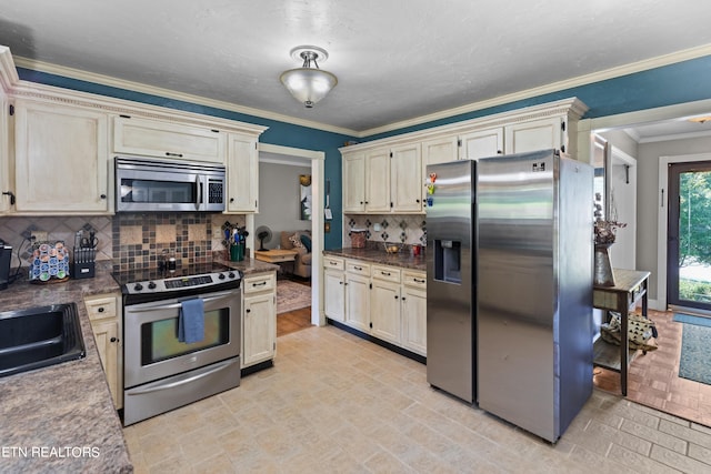 kitchen featuring crown molding, decorative backsplash, cream cabinets, and stainless steel appliances