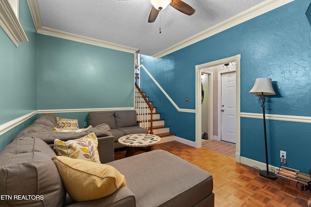 living room featuring parquet floors, crown molding, a textured ceiling, and ceiling fan