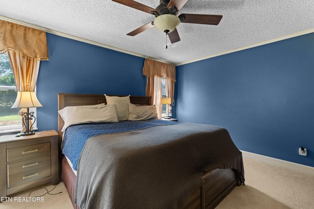 bedroom featuring light carpet, crown molding, a textured ceiling, and ceiling fan