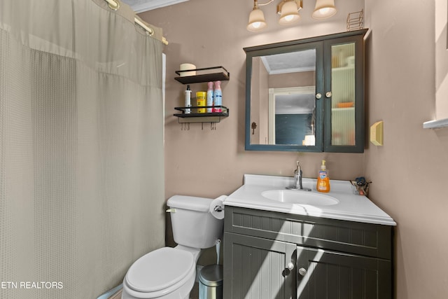 bathroom with vanity, a shower with shower curtain, ornamental molding, and toilet