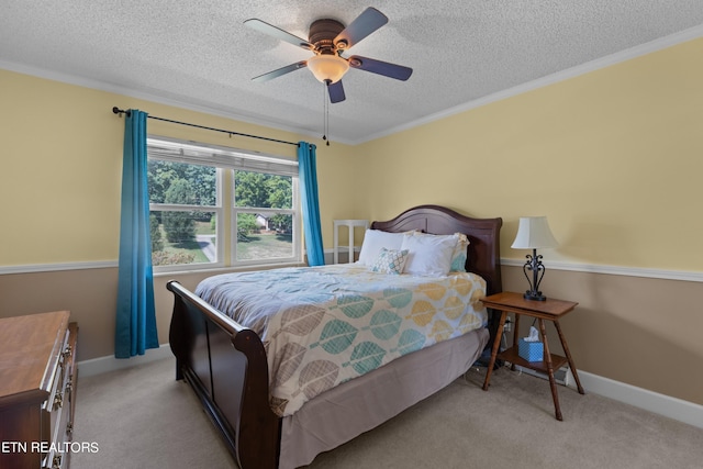 carpeted bedroom with crown molding, a textured ceiling, and ceiling fan