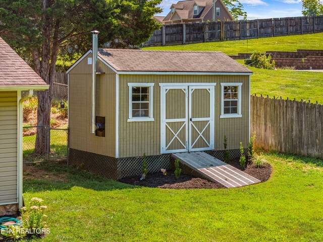 view of outbuilding with a lawn