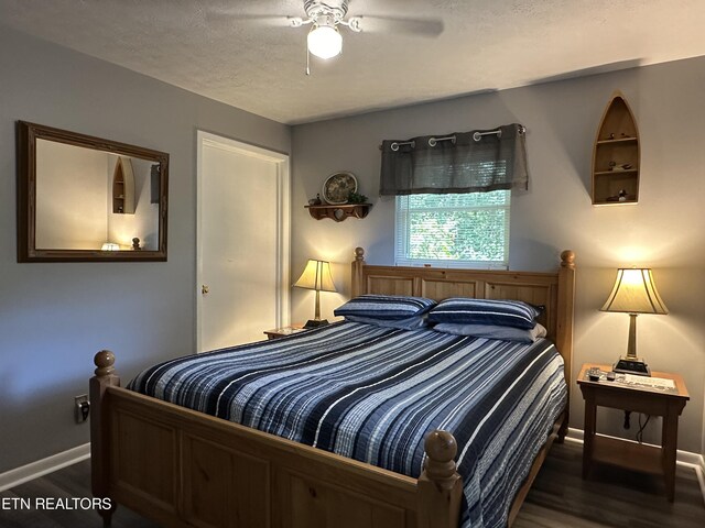 bedroom featuring a textured ceiling, ceiling fan, and dark hardwood / wood-style floors