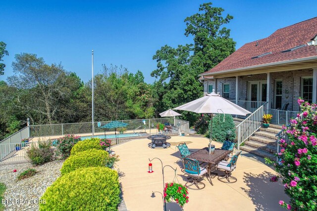 view of patio with a fenced in pool