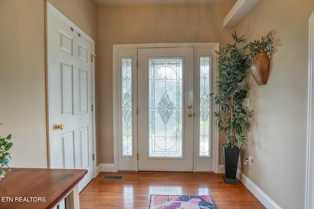 foyer with a healthy amount of sunlight and light hardwood / wood-style floors