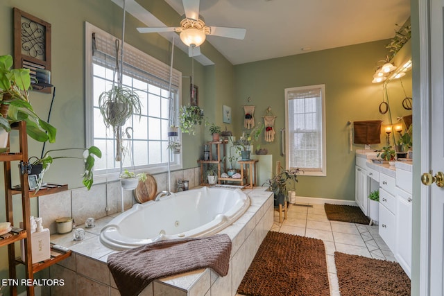 bathroom with vanity, tile patterned flooring, ceiling fan, and tiled bath