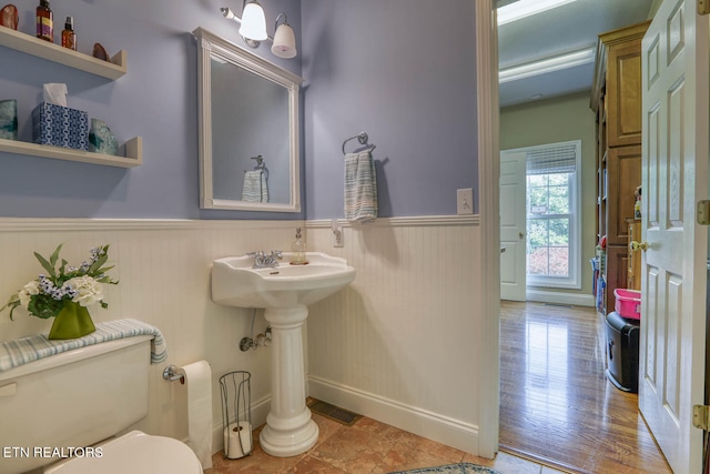 bathroom featuring wood-type flooring and toilet