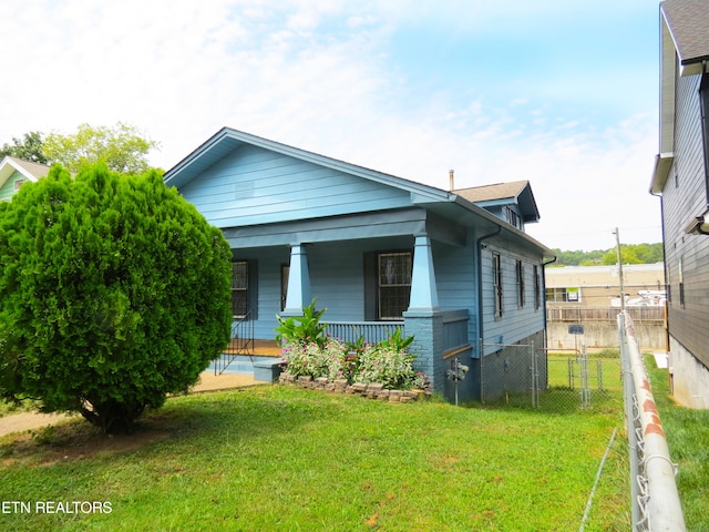 view of front of home featuring a front yard and a porch