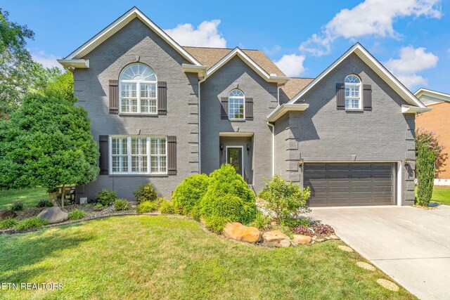 front of property featuring a garage and a front lawn