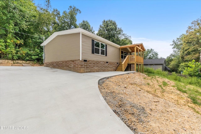 view of front of home featuring stairway and concrete driveway