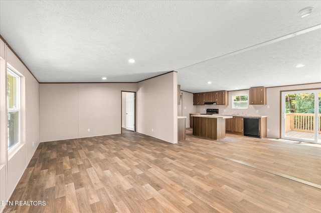 unfurnished living room with recessed lighting, light wood-style floors, and a textured ceiling