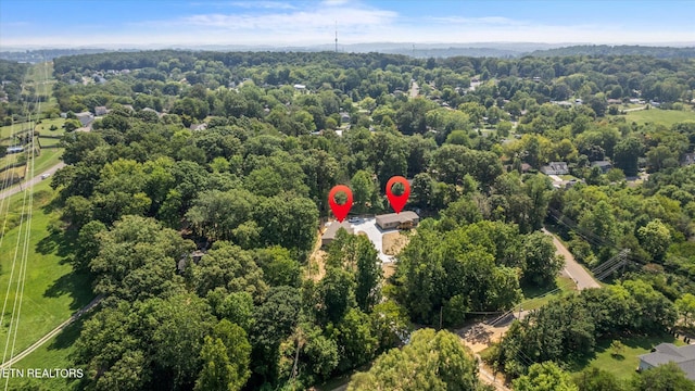 birds eye view of property with a view of trees