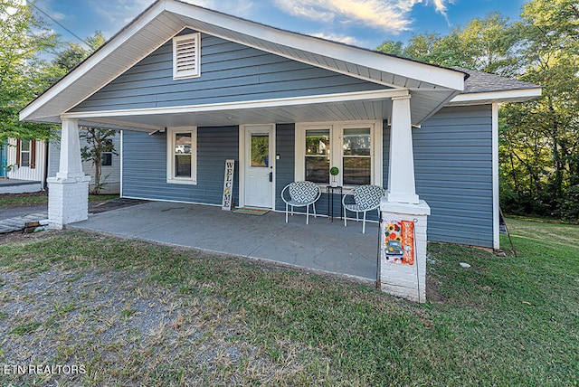 view of front of house featuring a front yard and a porch