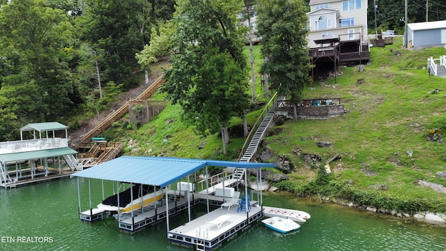 dock area with a water view, boat lift, and stairway