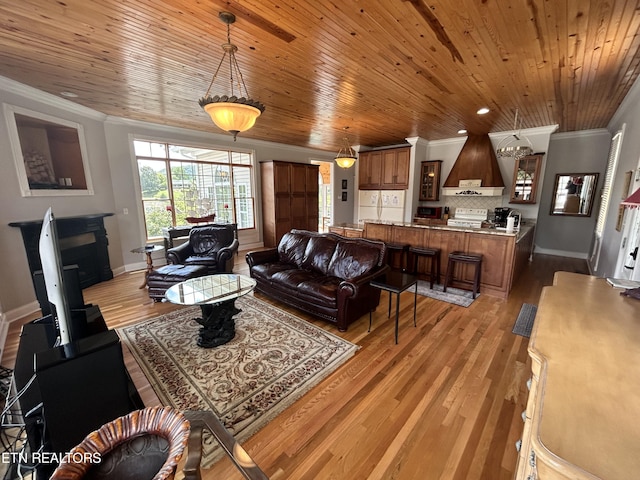 living room featuring ornamental molding, light wood-style flooring, and wood ceiling