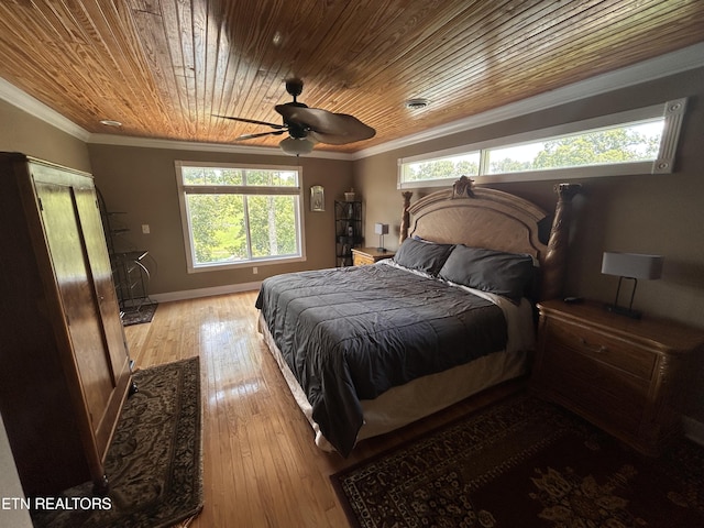 bedroom with light wood-type flooring, multiple windows, and crown molding