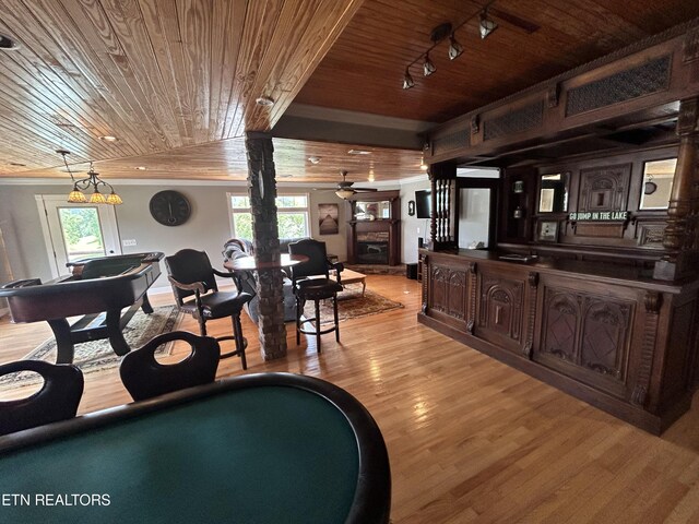 interior space featuring ceiling fan, light wood-type flooring, wooden ceiling, and track lighting