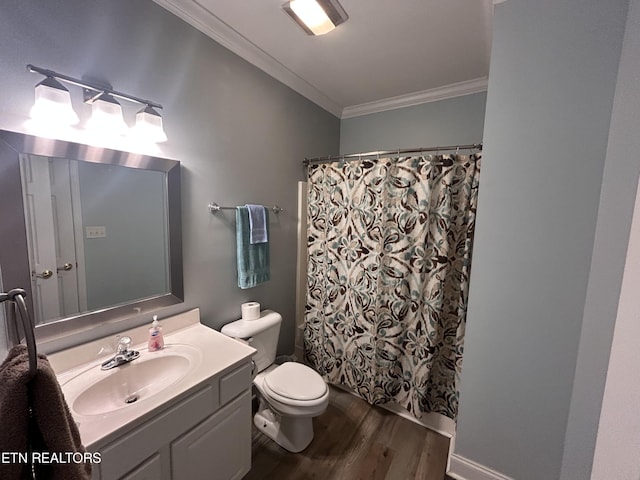 bathroom featuring toilet, a shower with shower curtain, wood finished floors, vanity, and crown molding