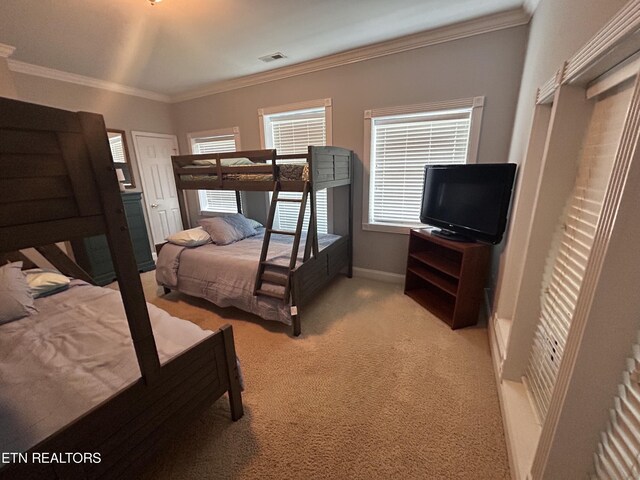 bedroom with carpet and crown molding