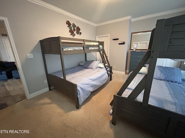 carpeted bedroom with baseboards and crown molding