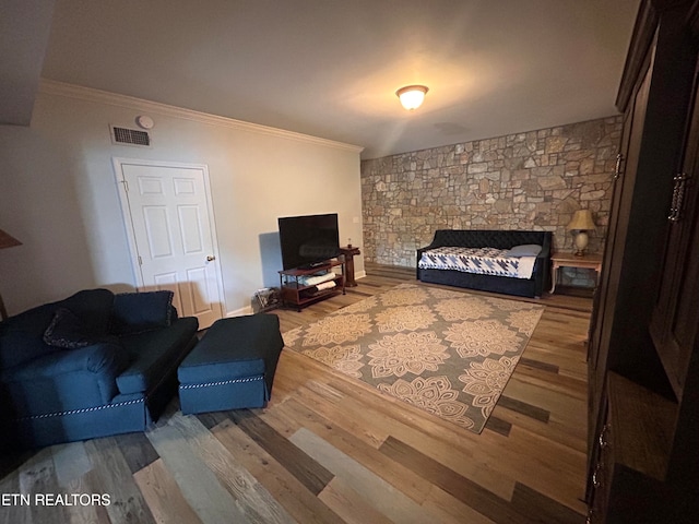 living room featuring hardwood / wood-style floors, a fireplace, and crown molding