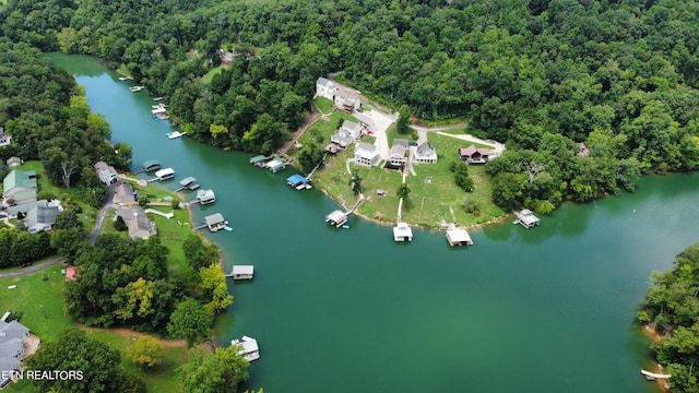 drone / aerial view featuring a water view and a forest view